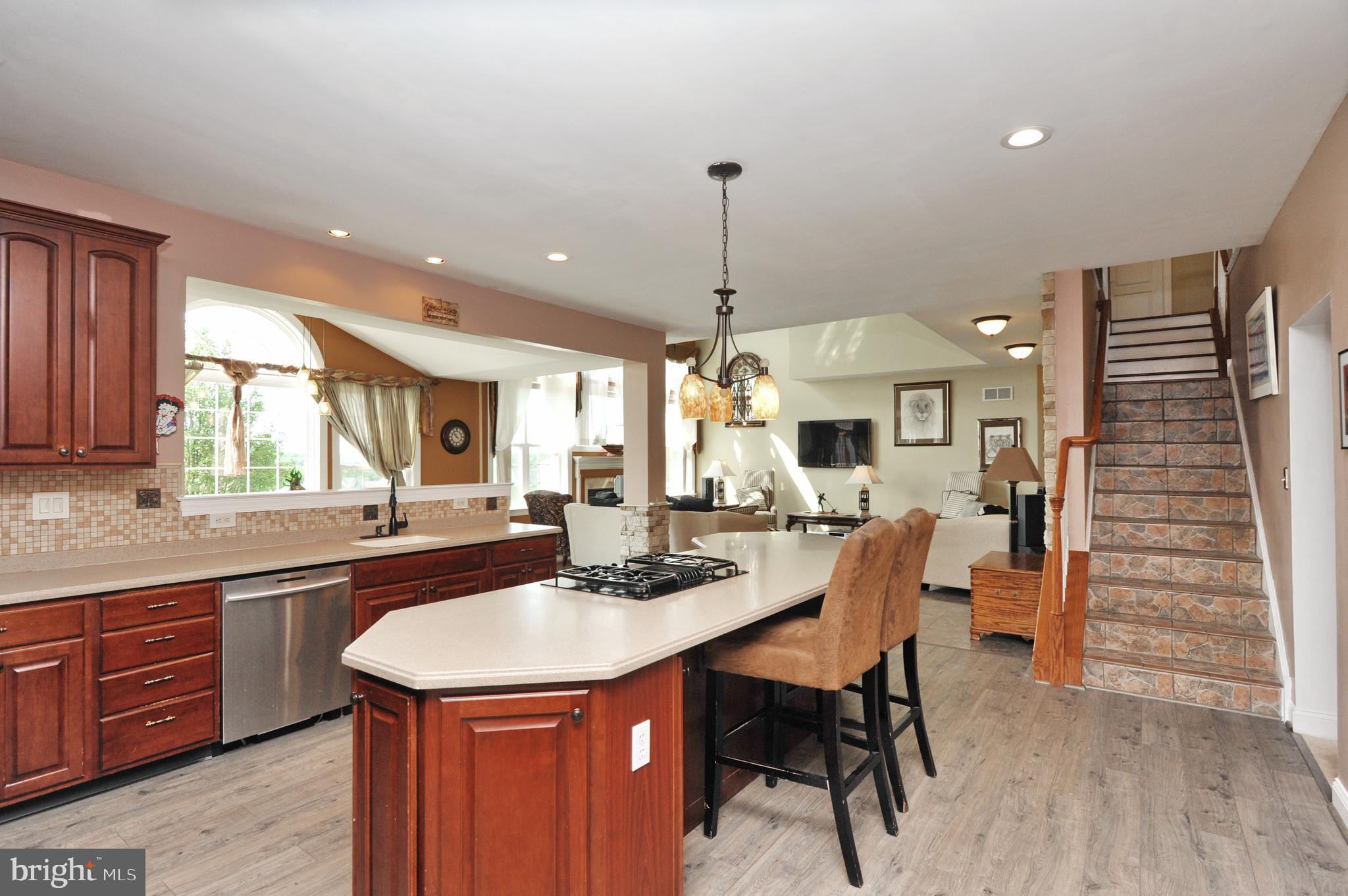 434 Hoffman Road Harleysville, PA 19438 - Photo 22 of 46 a dining hall with stainless steel appliances kitchen island a table and chairs in it