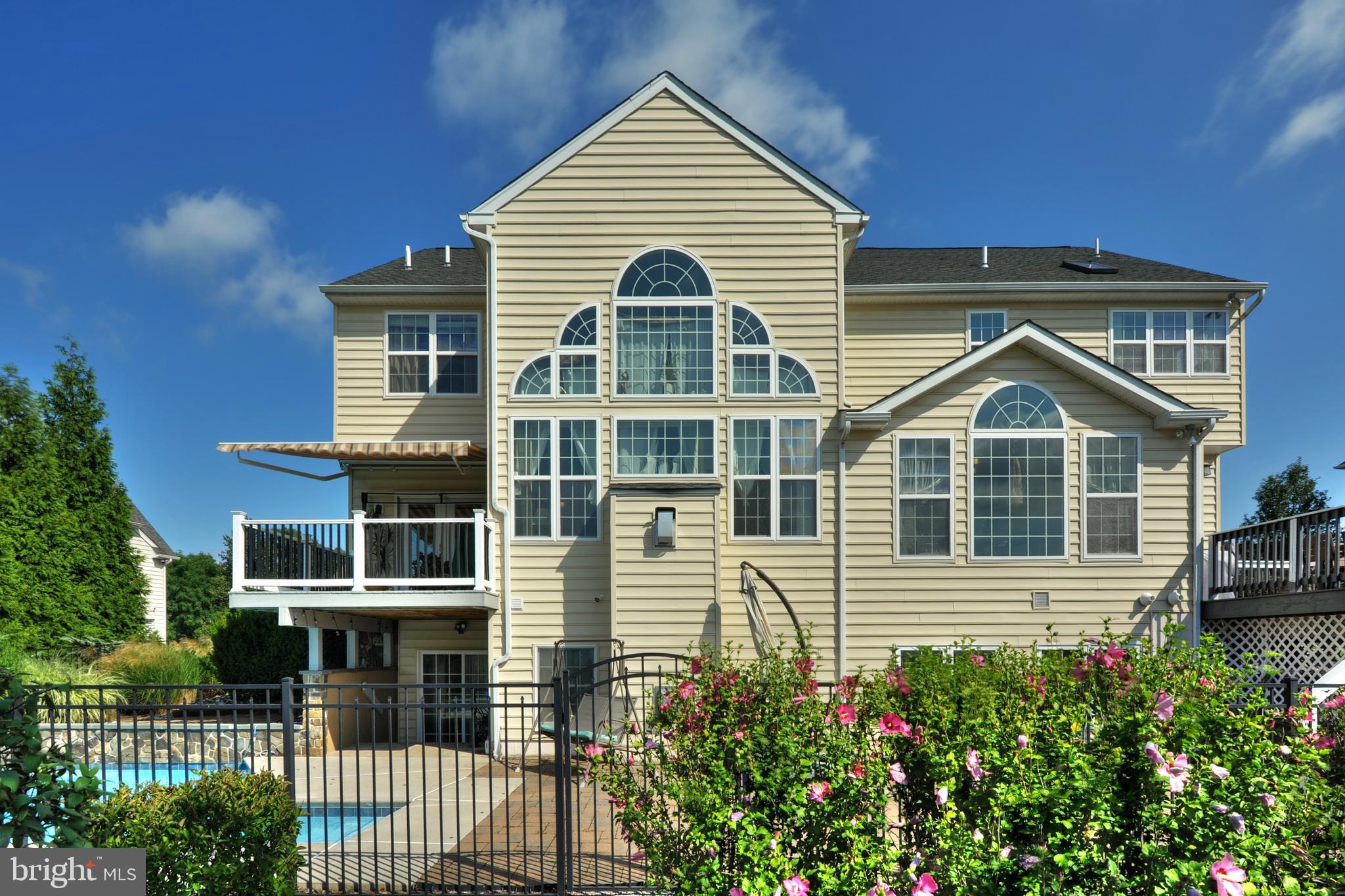 434 Hoffman Road Harleysville, PA 19438 - Photo 4 of 46 a view of a house with large windows and a small yard