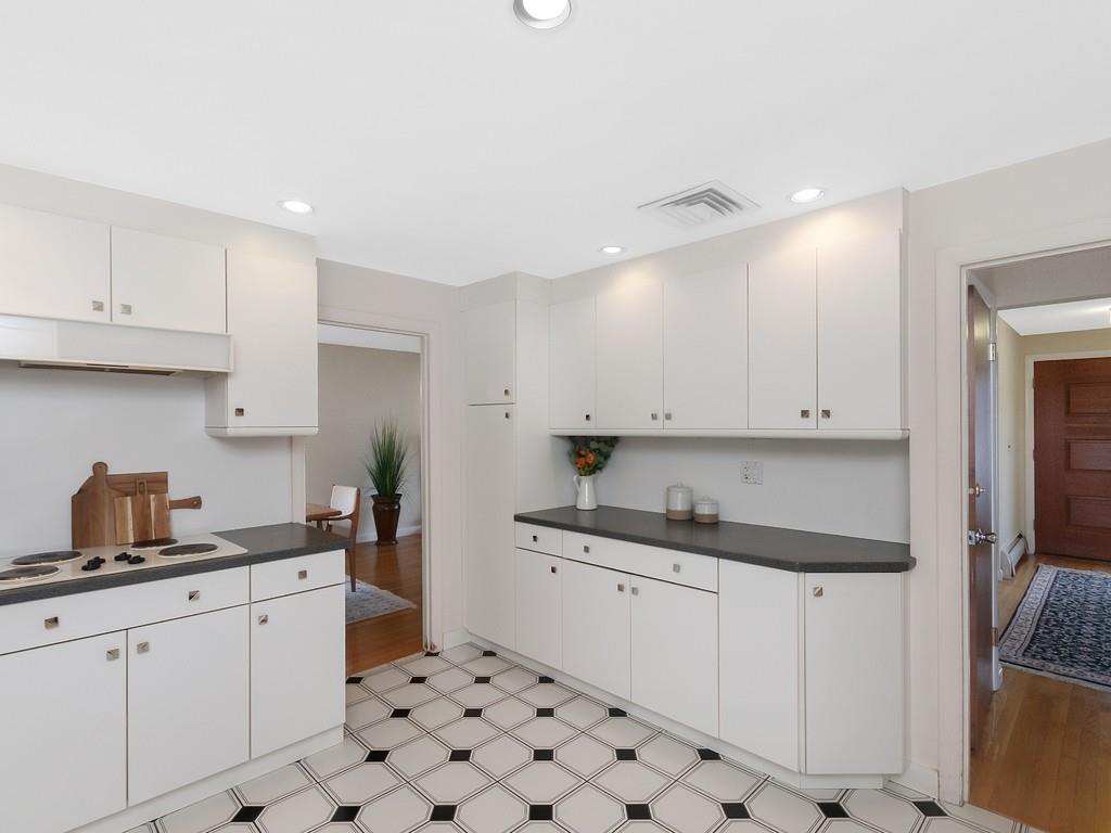 37 Slocum Road Boston, MA 02130 - Photo 11 of 27 a kitchen with granite countertop white cabinets and white appliances