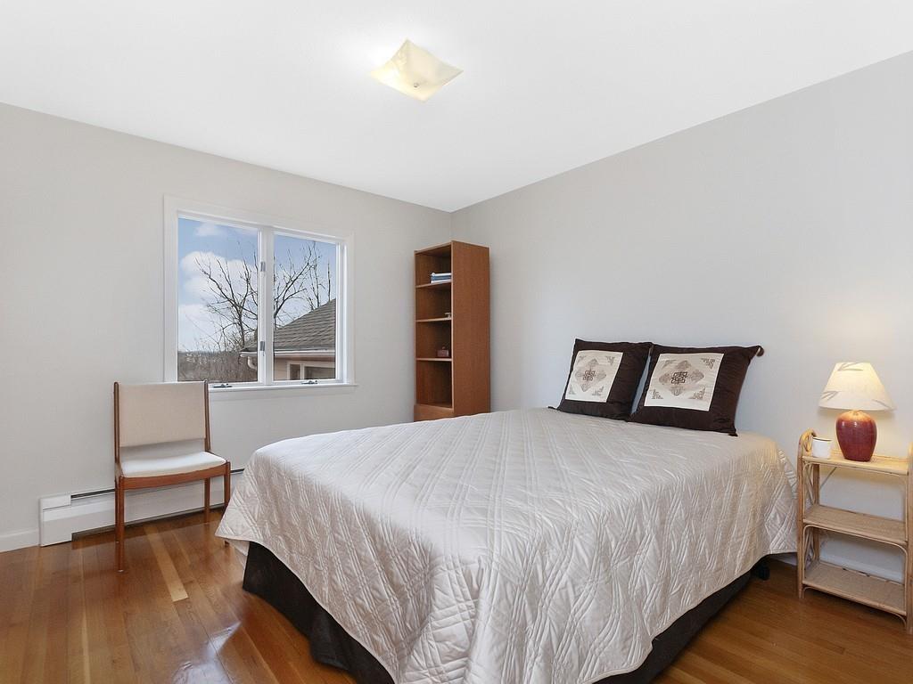 37 Slocum Road Boston, MA 02130 - Photo 13 of 27 a bedroom with a bed a chandelier and a window