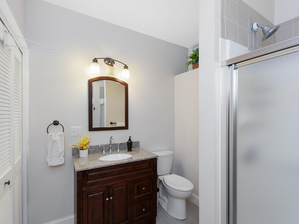37 Slocum Road Boston, MA 02130 - Photo 21 of 27 a bathroom with a toilet sink and mirror