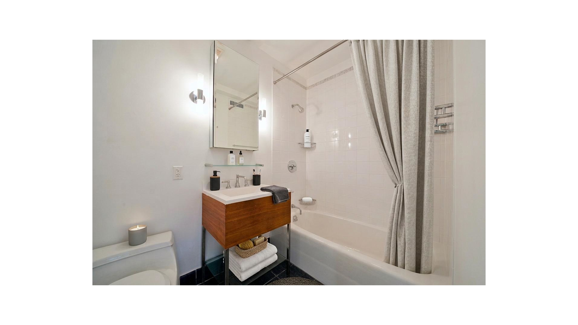 426 West 58th Street, Unit PH2 Manhattan, NY 10019 - Photo 7 of 11 a bathroom with a sink toilet and shower