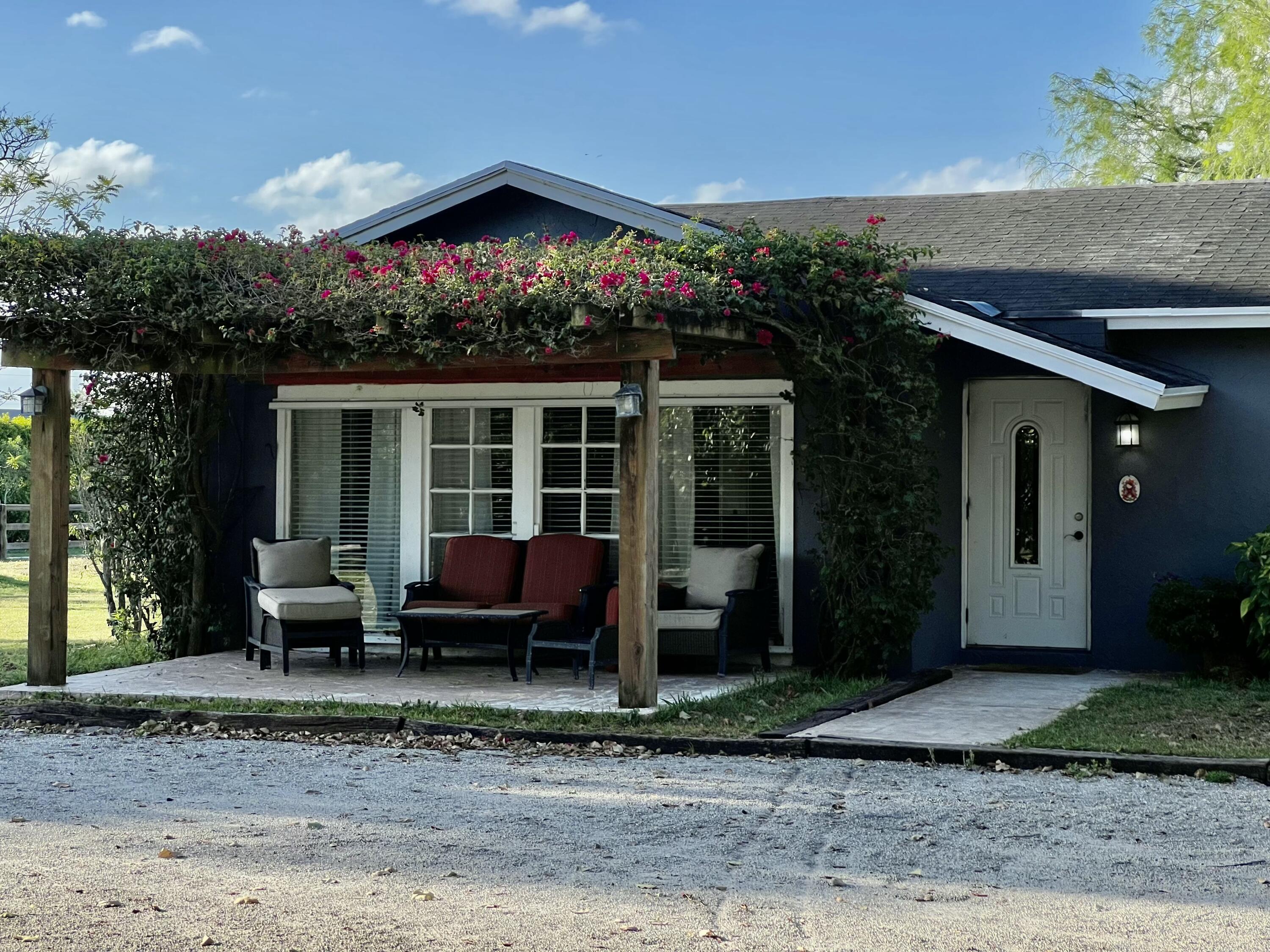 a view of a house with a yard and sitting area