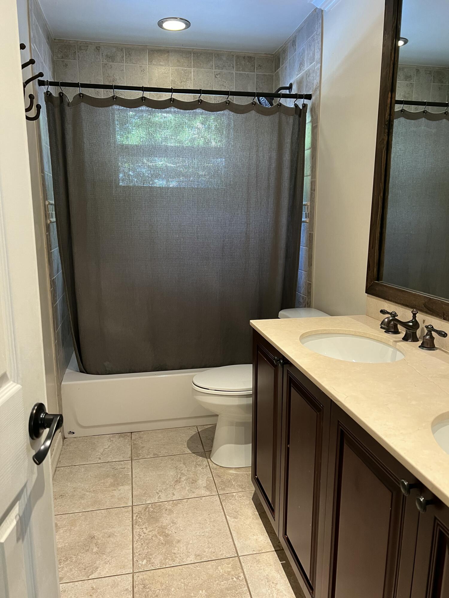 16163 16097 Rustic Road Wellington, FL 33470 - Photo 15 of 36 a bathroom with a granite countertop sink toilet and shower