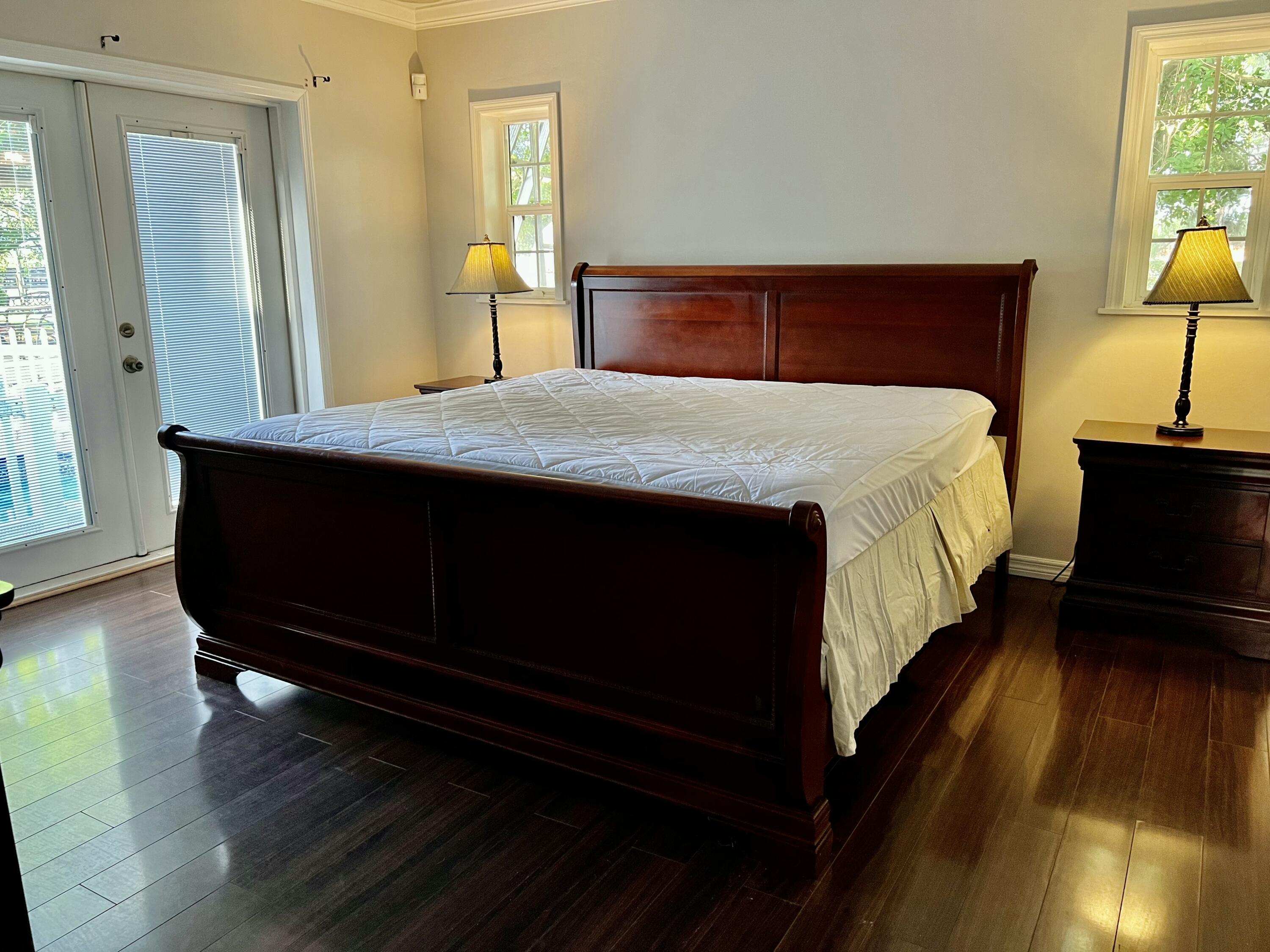 16163 16097 Rustic Road Wellington, FL 33470 - Photo 16 of 36 a bedroom with a bed and wooden floor