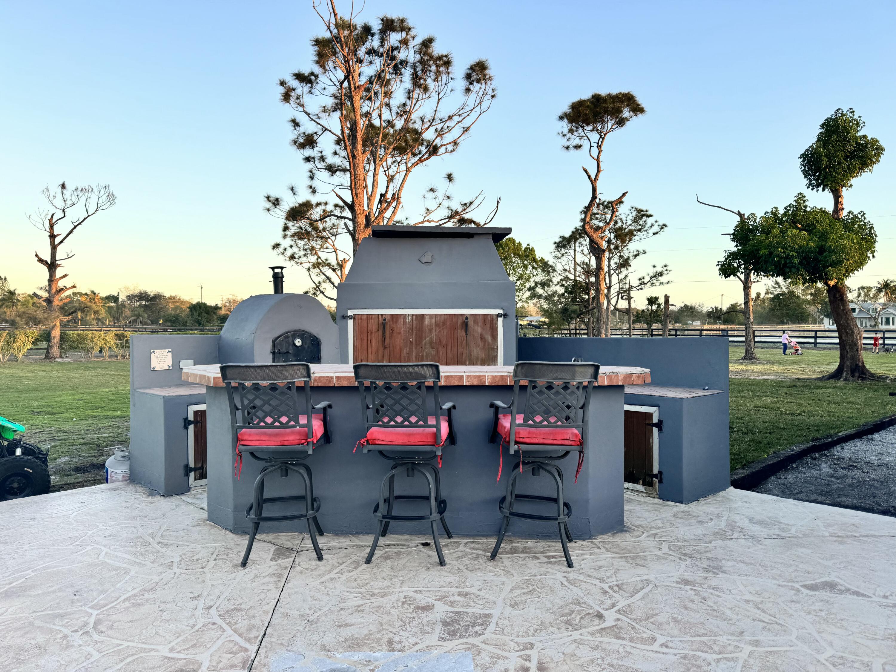 16163 16097 Rustic Road Wellington, FL 33470 - Photo 22 of 36 outdoor space with patio furniture
