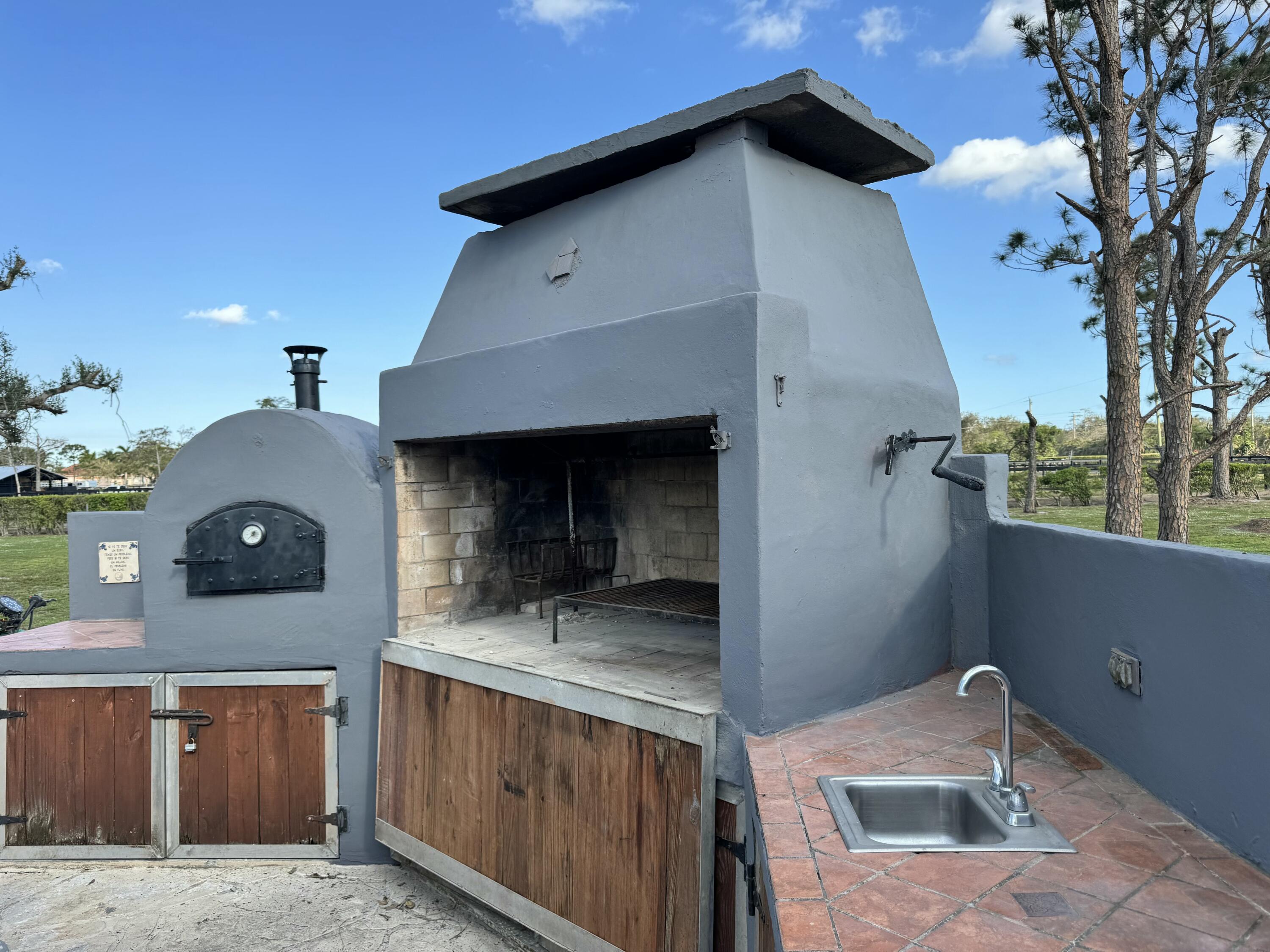 16163 16097 Rustic Road Wellington, FL 33470 - Photo 24 of 36 a front view of a house with yard