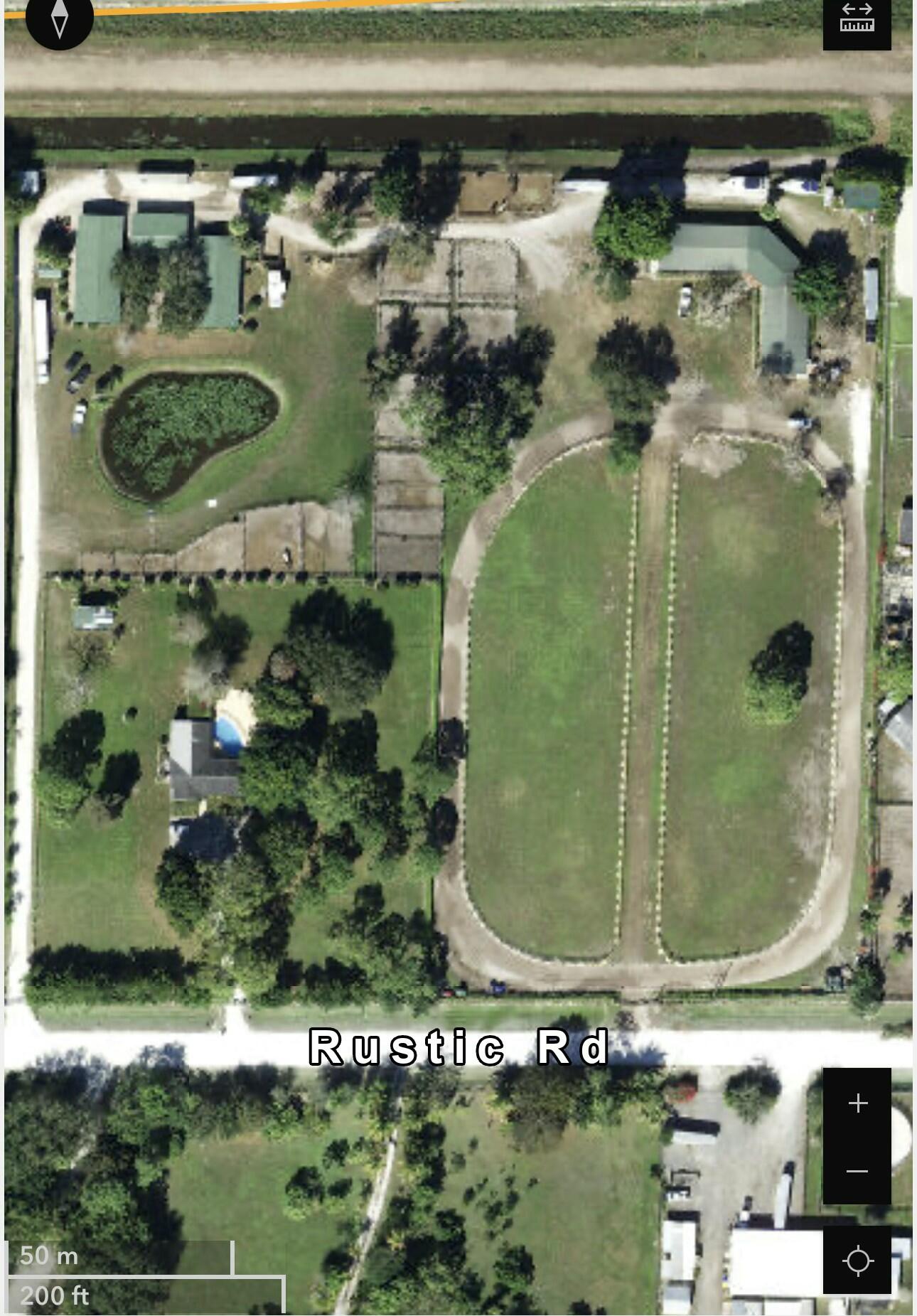 16163 16097 Rustic Road Wellington, FL 33470 - Photo 31 of 36 an aerial view of a residential houses with outdoor space