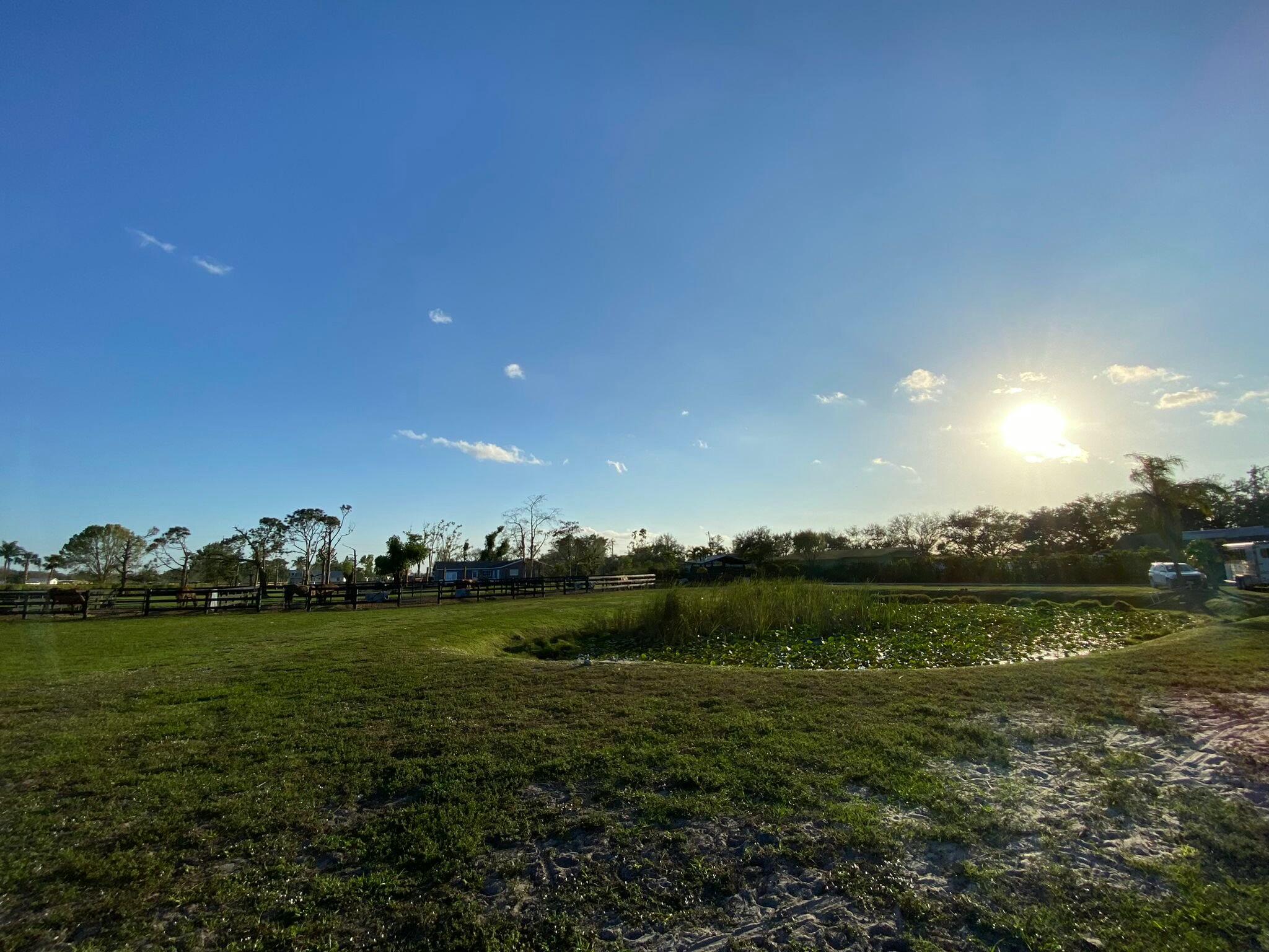 16163 16097 Rustic Road Wellington, FL 33470 - Photo 35 of 36 a view of a golf course with a lake