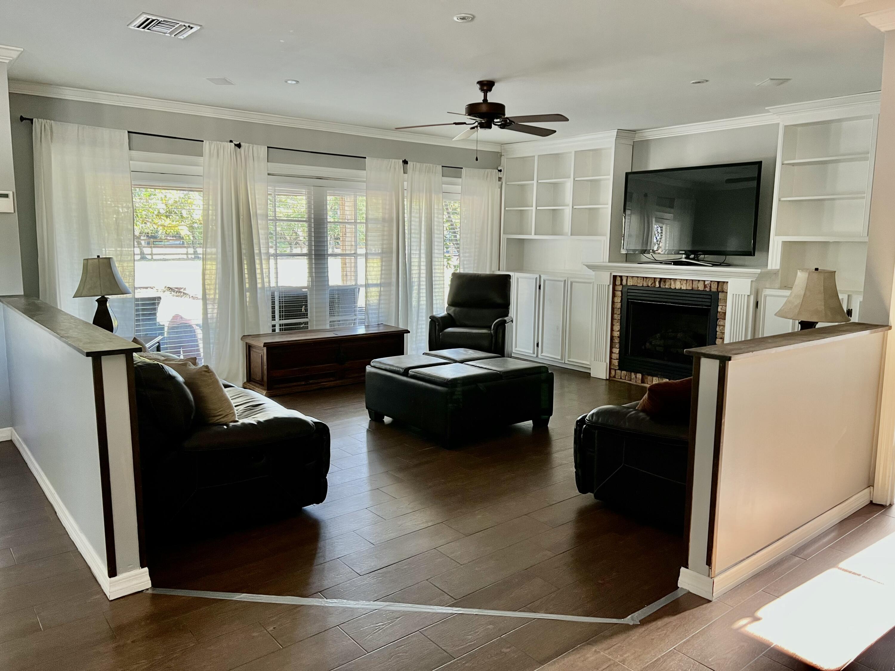 16163 16097 Rustic Road Wellington, FL 33470 - Photo 6 of 36 a living room with furniture and a flat screen tv