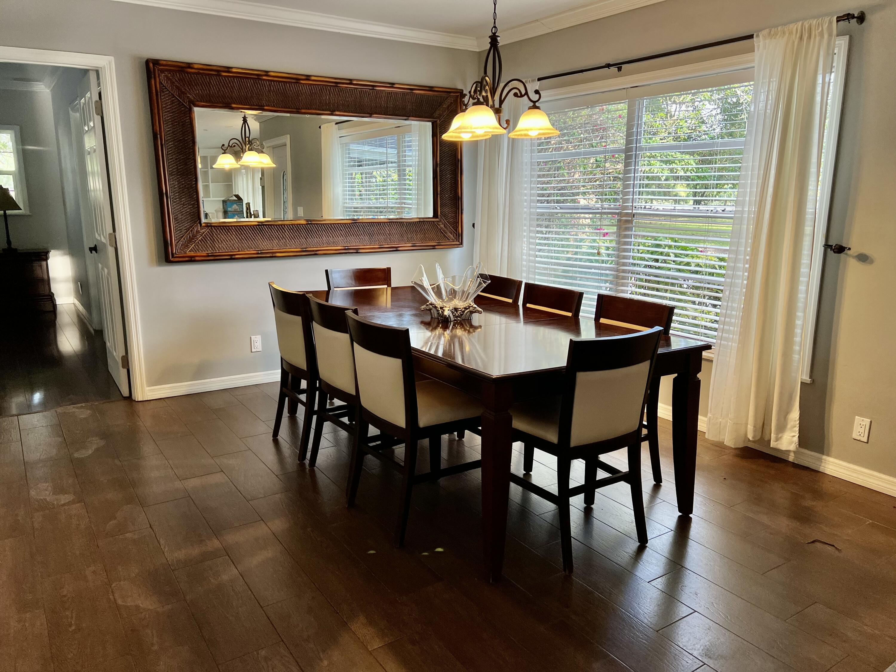 16163 16097 Rustic Road Wellington, FL 33470 - Photo 8 of 36 a view of a dining room with furniture window and wooden floor