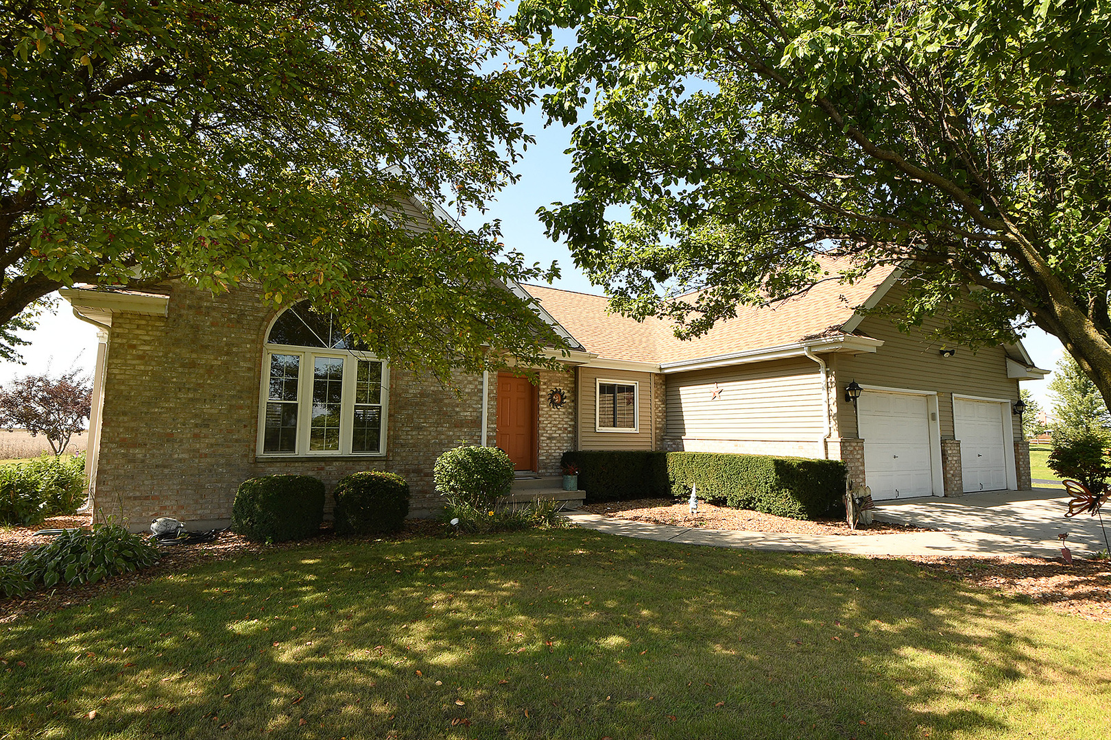 32220 South Cedar Road Manhattan, IL 60442 - Photo 1 of 46 a front view of a house with a garden and porch
