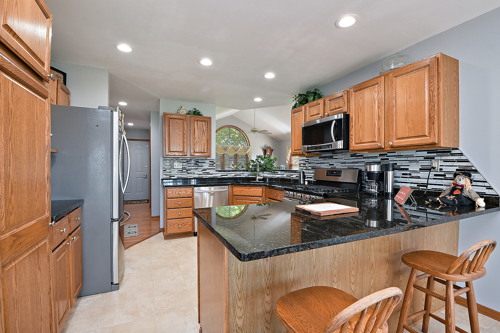 32220 South Cedar Road Manhattan, IL 60442 - Photo 13 of 46 a kitchen with stainless steel appliances granite countertop a refrigerator a stove top oven and a sink with wooden floor
