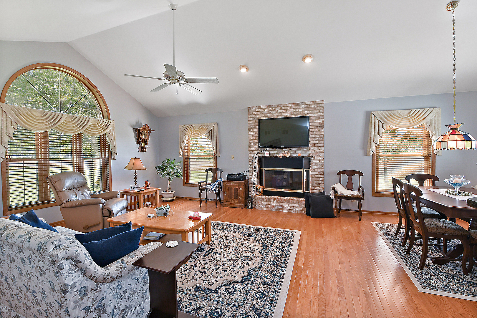 32220 South Cedar Road Manhattan, IL 60442 - Photo 5 of 46 a living room with furniture a fireplace and a flat screen tv