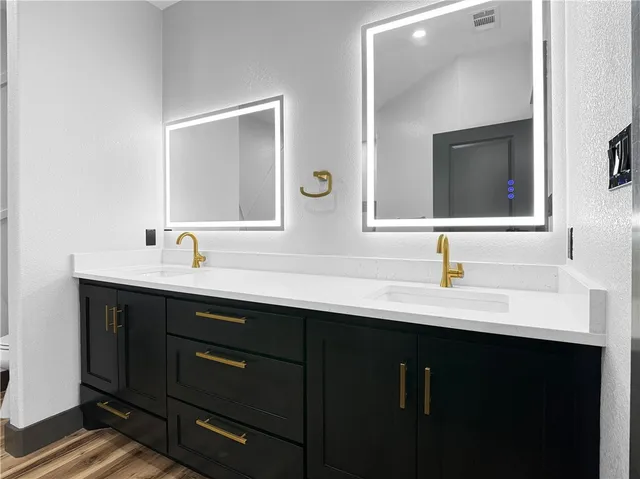a bathroom with a double vanity sink and mirror