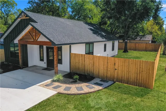 a backyard of a house with table and chairs