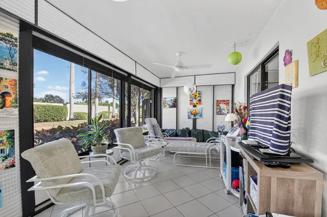 a living room with furniture large window and flat screen tv