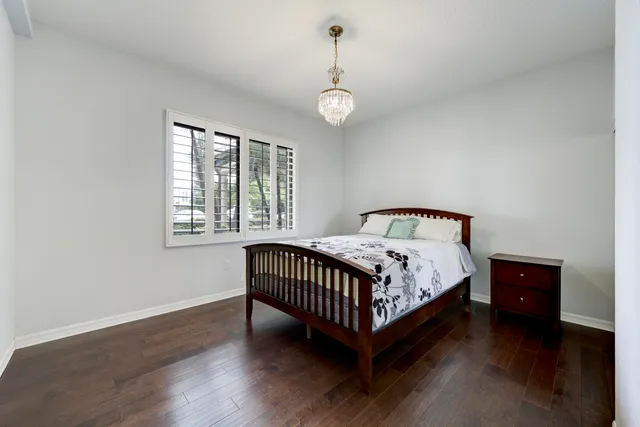 a bathroom with a granite countertop sink toilet mirror and bathtub