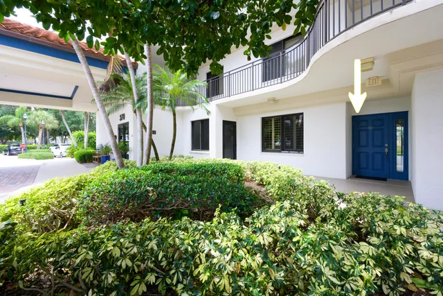 a view of a garden with tall buildings
