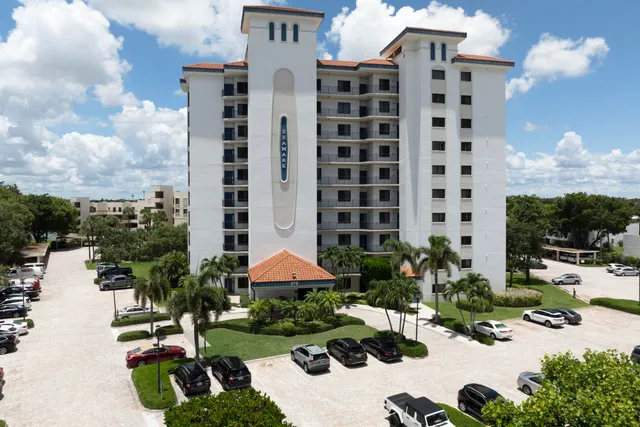 a view of a lake with couches and city view