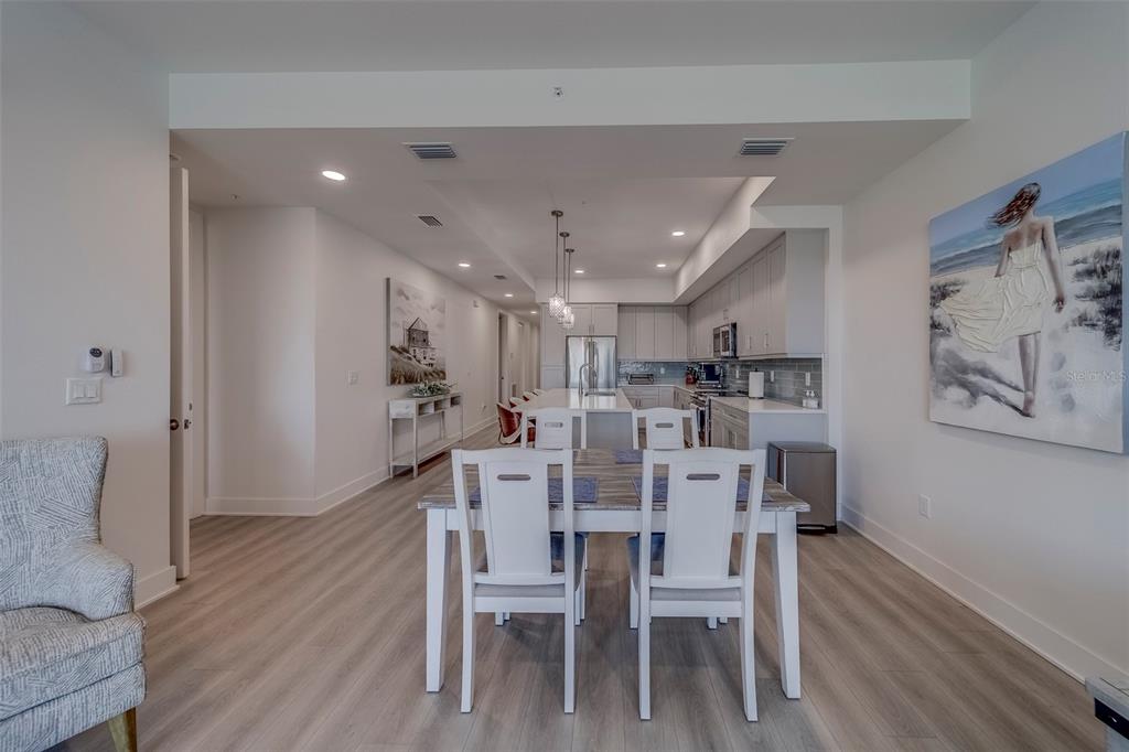 400 150th Avenue, Unit 301 Madeira Beach, FL 33708 - Photo 12 of 66 a view of a dining room with furniture and wooden floor