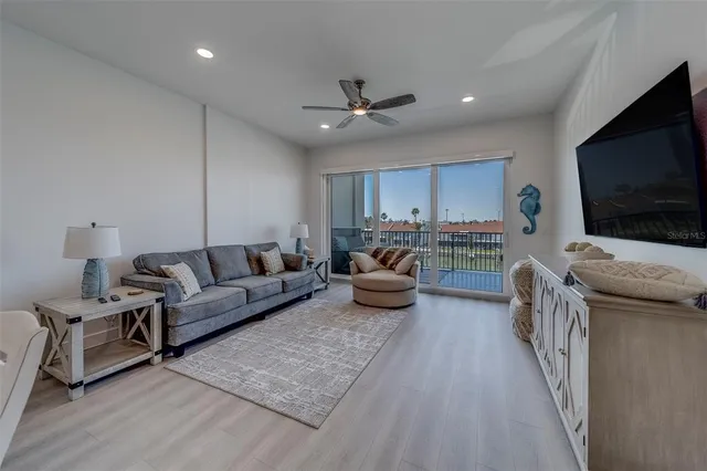 a bedroom with a bed and a flat tv screen on dresser