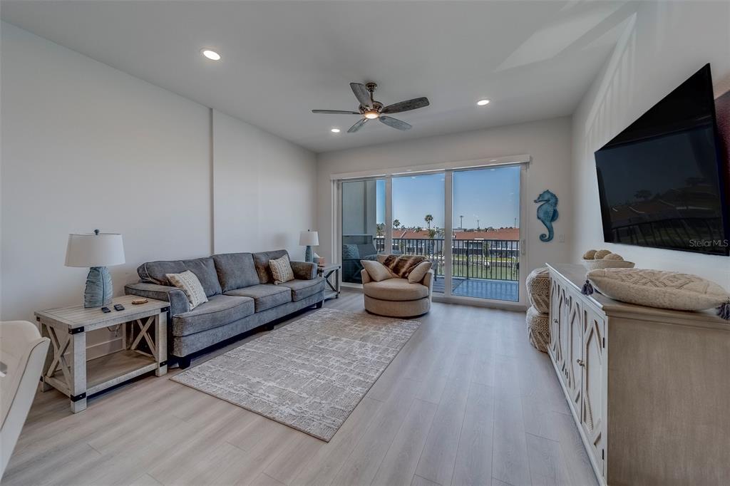 400 150th Avenue, Unit 301 Madeira Beach, FL 33708 - Photo 14 of 66 a living room with furniture and a flat screen tv