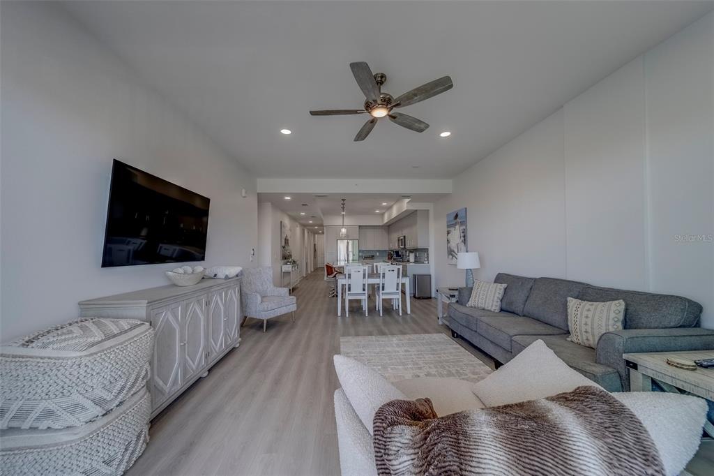 400 150th Avenue, Unit 301 Madeira Beach, FL 33708 - Photo 16 of 66 a living room with furniture and a flat screen tv