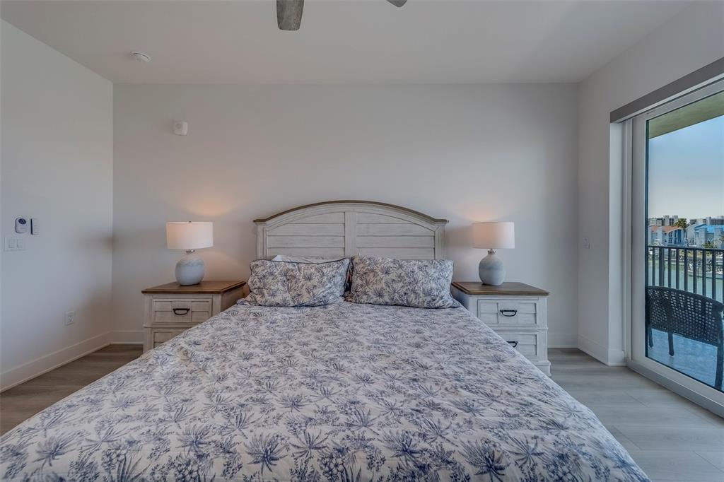 400 150th Avenue, Unit 301 Madeira Beach, FL 33708 - Photo 19 of 66 a bedroom with a bed and a window