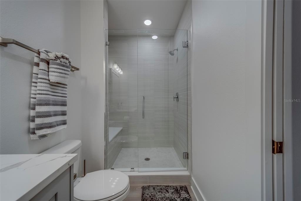 400 150th Avenue, Unit 301 Madeira Beach, FL 33708 - Photo 48 of 66 a bathroom with a shower a toilet and a sink