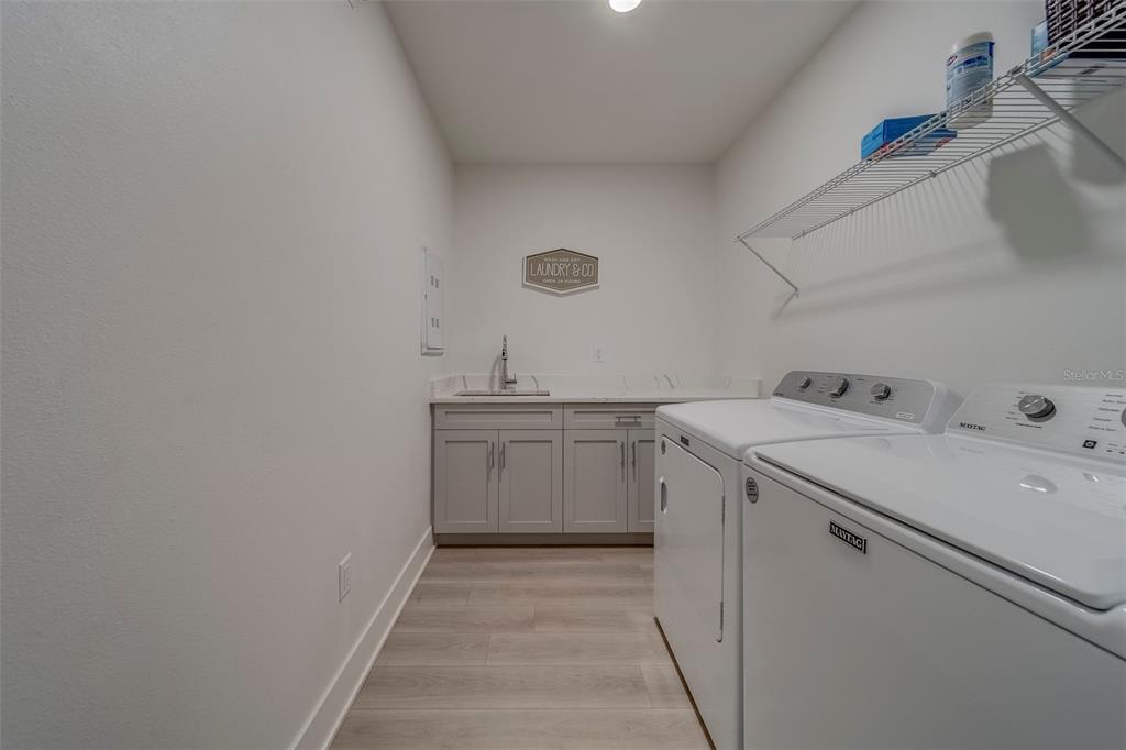400 150th Avenue, Unit 301 Madeira Beach, FL 33708 - Photo 49 of 66 a utility room with cabinets washer and dryer