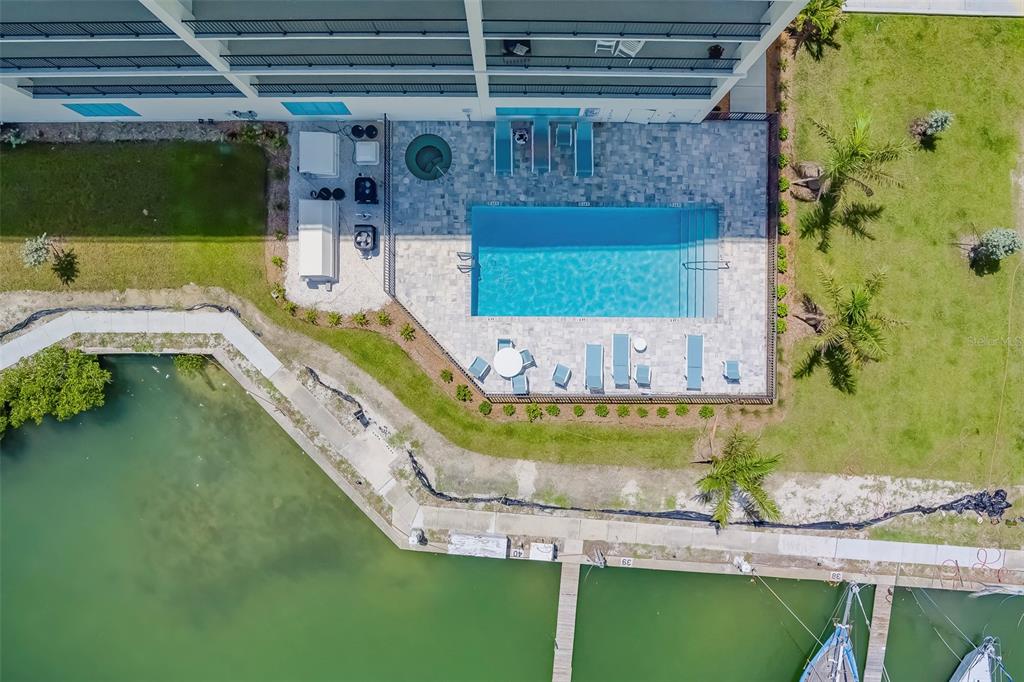 400 150th Avenue, Unit 301 Madeira Beach, FL 33708 - Photo 53 of 66 a view of a swimming pool with a yard