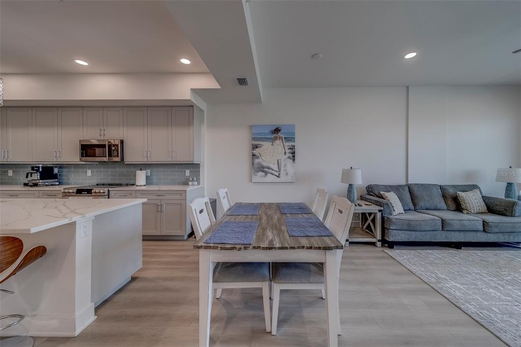 400 150th Avenue, Unit 301 Madeira Beach, FL 33708 - Photo 10 of 66 a living room with kitchen island furniture and a kitchen view