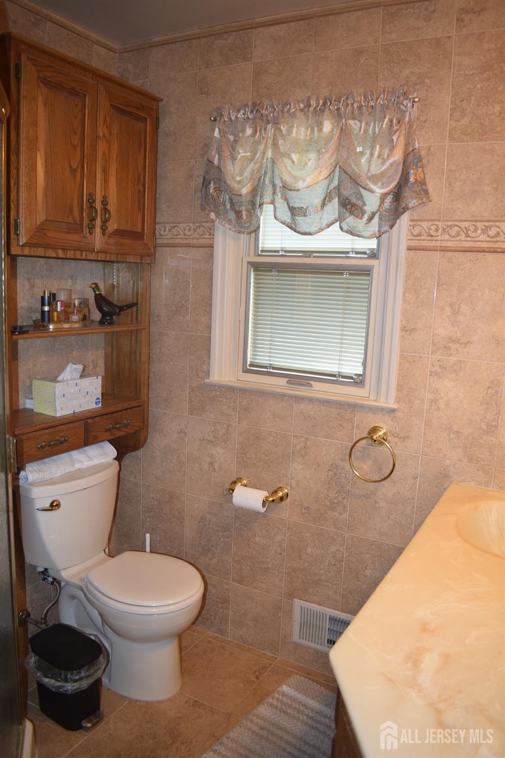 15 Cutter Avenue Edison, NJ 08820 - Photo 14 of 32 a bathroom with a toilet sink and mirror