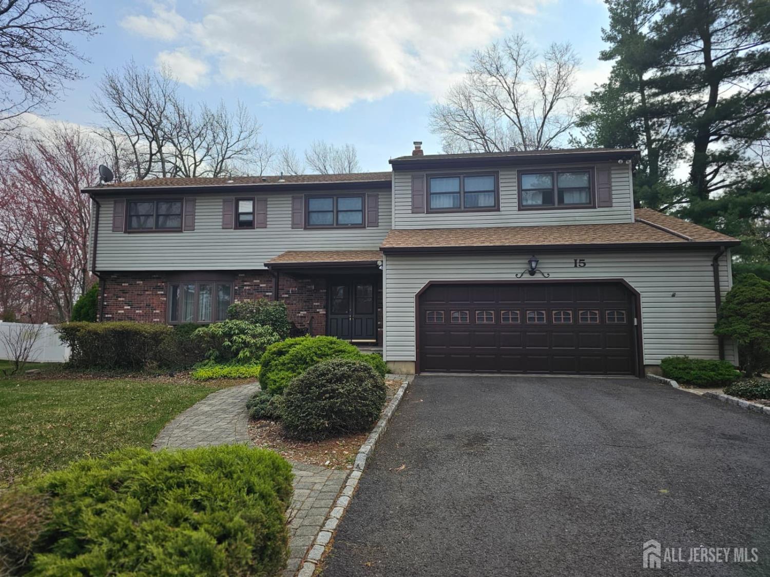 15 Cutter Avenue Edison, NJ 08820 - Photo 28 of 32 a front view of a house with a garden and garage