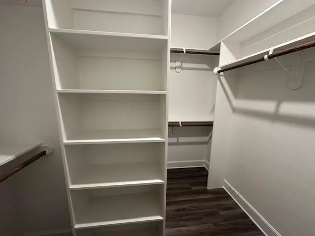 a view of walk in closet with empty racks