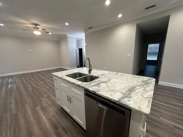 a kitchen with a sink and chandelier