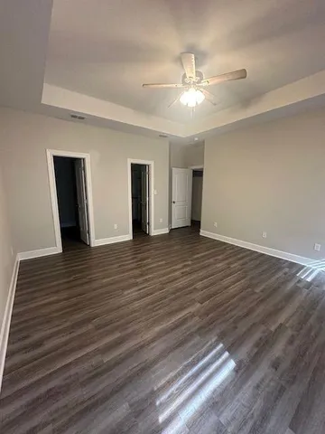 a view of an empty room and wooden floor
