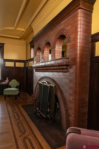 a front view of a house with barbeque and wooden floor