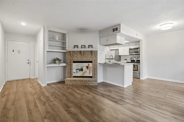 a view of kitchen with sink and wooden floor