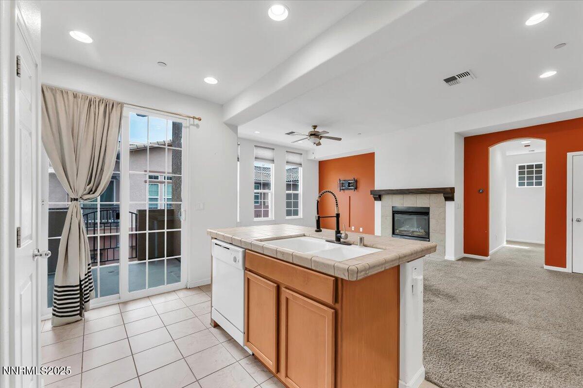 1932 Wind Ranch Road, Unit C Reno, NV 89521 - Photo 20 of 29 a kitchen with granite countertop a sink stove and cabinets