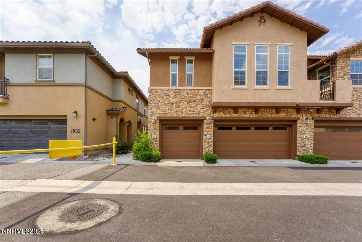 1932 Wind Ranch Road, Unit C Reno, NV 89521 - Photo 6 of 29 a front view of a house with a yard and a garage