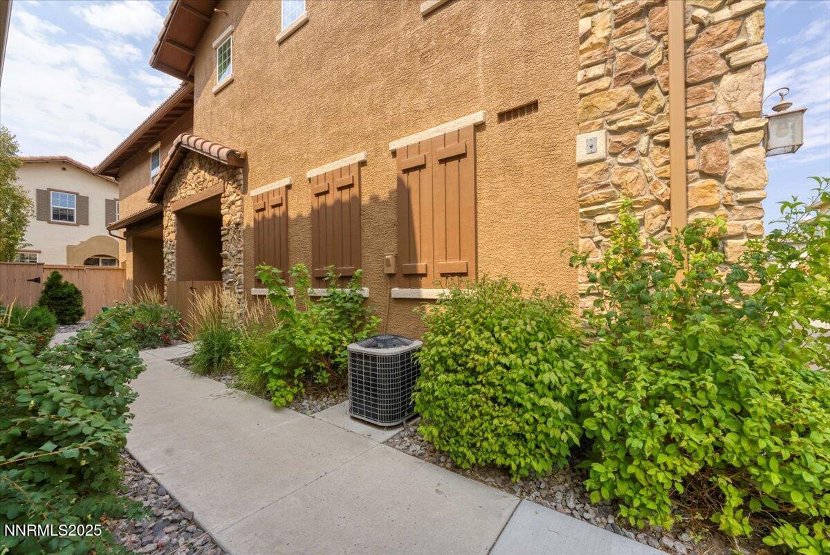 1932 Wind Ranch Road, Unit C Reno, NV 89521 - Photo 8 of 29 a couple of potted plants in front of a building