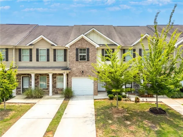 a view of a white house with a swimming pool