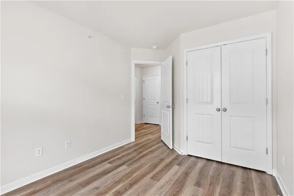 a view of an empty room and wooden floor