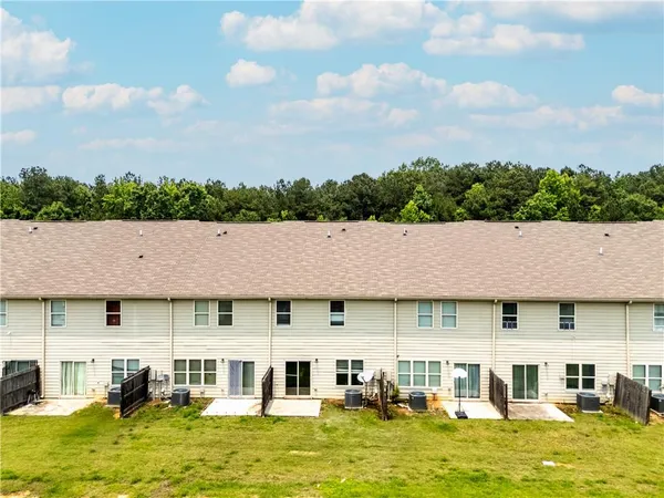 an aerial view of a house with a swimming pool table and chairs