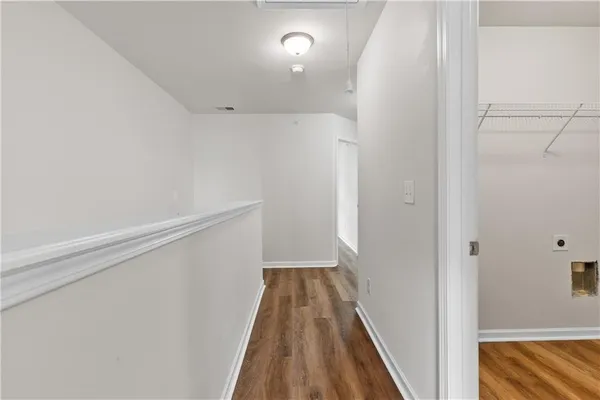 a view of hallway with wooden floor
