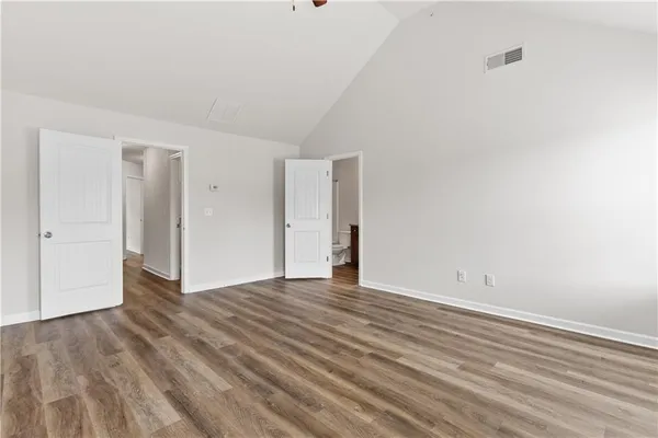 a view of an empty room with wooden floor