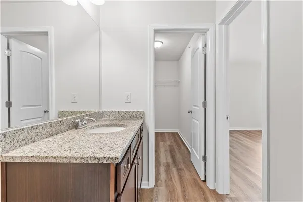 a bathroom with a granite countertop sink and a mirror