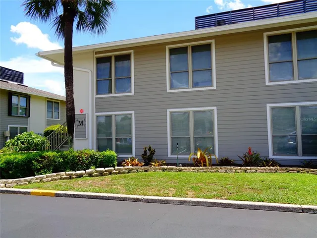 a front view of house and yard with green space